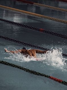 a man is swimming in the water with no shirt on