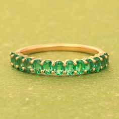 14k Emerald Band Ring, Half Eternity Wedding Band Women, Oval Cut Gemstone Ring, Dainty Stacking Ring, Green Gemstone Ring, Mother Day Gifts Item Detail: Material: 925 Sterling Silver, Yellow Gold, Rose Gold Gemstone: Emerald ( Lab Created CZ ) Shape: Oval Size: 3x5mm Color: Green  Stone Weight: 2.15 Ct approx. NOTE: We use good quality gemstone. Therefore they might vary a little in color, hue and reflection. But I assure you will like it. We use base material 925 solid silver then gold plating or rose gold on the ring. If you will do care the ring of gold plating it will go last longer. SHOP GemPlaceJaipur> https://www.etsy.com/in-en/shop/Gemplacejaipur FAST, FREE SHIPPING AND HANDLING TIME Handling Time: We take handling time of 3 Business Day from the date of receipt of the payment aft Oval Emerald Stackable Rings, Oval Stackable Anniversary Rings, Oval Half Eternity Ring As Gift, Anniversary Oval Stackable Rings, Stackable Oval Crystal Ring For Promise, Classic Oval Stackable Emerald Ring, Oval Half Eternity Band As Gift, Oval Eternity Band With Prong Setting For Promise, Oval Stackable Crystal Ring Fine Jewelry