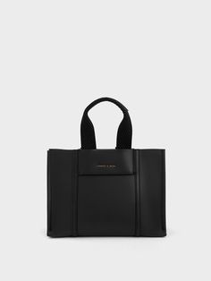 Whether you're running errands or headed out for brunch, the mini Shalia tote bag in black is a style essential that will keep everything you need by your side. In all-black for an effortlessly cool aesthetic, this chic bag is as structured as it is stylish. Carry yours by the supportive and thick double handles or clip on the sleek chain handle to add edge to your ensemble. Chic Black Bags For On-the-go, Functional Top Handle Shoulder Bag For Shopping, Functional Black Shoulder Bag For Shopping, Minimalist Black Satchel With Detachable Handle, Functional Black Top Handle Bag, Trendy Black Bags For Work, Casual Black Bag For Work, Black Bags With Removable Pouch, Black Bags With Removable Pouch For Work