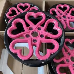 pink and black heart shaped wheels in a box