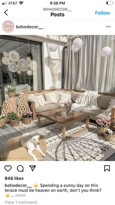 a living room with lots of furniture and decorations on the walls, in front of a window