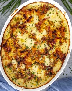 a baked dish with cheese and herbs in it