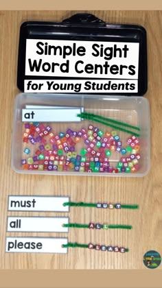 some beads are in a plastic container on a wooden table with labels and magnets