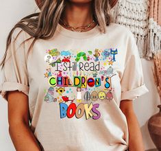 Celebrate your love for children's literature with our "I Still Read Children's Books" t-shirt, featuring a delightful collage of iconic characters including Pete the Cat, The Hungry Caterpillar, Piggie and Gerald, the crayons from "The Day the Crayons Quit," Clifford, and the mouse from "If You Give a Mouse a Cookie." This tee is perfect for educators who cherish these timeless stories and want to share their passion for reading with their students. PRODUCT FEATURES 👚 Solid colors: 100% Cotton Book Character Shirts For Teachers, Piggie And Gerald, The Hungry Caterpillar, Mouse A Cookie, Literary Characters, Pete The Cat, Book Character, Book Tshirts, Teacher Tees