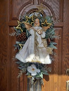 a christmas wreath with an angel on it