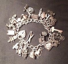 This piece is 100% sterling. There are 24 charms and one spring clasp. Every charm is articulated and most of them are moving charms. The man on the donkey charm has red enamel on his sombraro. All of the charms are linked to the bearcelet with a soldered jump ring each. There are 2 charms that are missing their parts, the piano 'lid' and the meatlocker door. Buyers are welcome to write with any questions and I am happy to send as many pictures as you need.  New York- 1921 -1959.  Thanks for looking. Silver Charm Bracelets, Vintage Sterling Silver Charm Bracelet, Silver Charms For Bracelets, Charming Bracelet, Artsy Jewelry, Bus Terminal, Vintage Sterling Silver Charms, Vintage Jewelry Crafts, Vintage Charm Bracelet