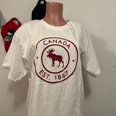 Canada Souvenir Tee Shirt Size Large Unisex Please Send Me Offers :) Casual White Screen Print Shirt, Casual White Print Pre-shrunk Shirt, Casual Shirt With White Front Print, Casual Fan Merchandise Shirt With Text Print, Casual Pre-shrunk Shirt For Fan Merchandise, Casual Pre-shrunk Shirt For Fans, Casual White Print Crew Neck Shirt, Casual Short Sleeve Fan Merchandise Shirt, Casual Crew Neck Shirt For Fan Merchandise