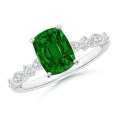 an emerald and diamond ring with white diamonds on the band, set in 18k white gold