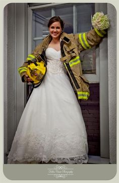 a woman in a wedding dress and fireman jacket