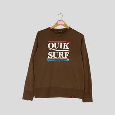 Vintage Rare QUIKSILVER Crewneck Sweatshirt Big Logo QUIKSLILVER Surf Jumper Pullover QUIKSILVER Sweater Brown Colour Unisex Medium Size CONDITION :- ✅GOODUSED CONDITION. ✅NO STAINS  ✅NO HOLE ITEM DESCRIPTION:- ✅SIZE: M ✅MATERIAL : COTTON ✅THIS USED & VINTAGE ITEMS, SO DON'T EXPECTED IT TO BE LIKE NEW CONDITION!! MEASUREMENT:- ✅ARMPIT TO ARMPIT : 19 INCH ✅LENGHT BACK COLOR/NECK TO HEM : 25 INCH ✅SHOWLDER : 18 ✅SLEEVE LENGTH: 22.5 INCH PLEASE REFER PHOTO BEFORE ORDER ALL MEASUREMENTS ARE TAKEN WI Brown Crew Neck Sweater For Streetwear, Vintage Sweater With Letter Print And Long Sleeves, Brown Crew Neck Top With Letter Print, Vintage Long Sleeve Sweater With Letter Print, Brown Cotton Crew Neck Sweater, Brown Long Sleeve Sporty Tops, Sporty Brown Long Sleeve Tops, Retro Brown Crew Neck Sweatshirt, Brown Long Sleeve Top With Graphic Print