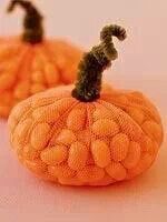 two fake pumpkins sitting next to each other