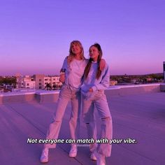 two women standing on top of a roof next to each other with the caption not everyone can match with your vibe