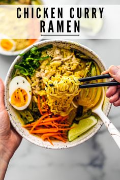 two hands holding chopsticks over a bowl of chicken curry ramen