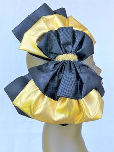 Experience  our luxurious 12in x 12in black bow, embellished by a lavish 10in x 10in gold bow and a chic 7in x 6in black bow artfully layered on top.  The striking combination exudes sophistication and grandeur, making it a statement accessory for any special occasion.  Adorned with a regal gold closure, the design radiates an air of refined elegance.  Resting gracefully on a 13in x 3/4in headband.  Our exclusive bows are thoughtfully crafted by a talented mother-daughter duo, pouring their pass Black Ribbon Bow For Evening, Adjustable Satin Bow For Evening, Luxury Detachable Bow For Evening, Adjustable Black Bow With Ribbon, Adjustable Gold Bow For Party, Gold Ribbon Bow For Party, Chic Black Bow For Black Tie Events, Gold Satin Bow For Gift, Gold Decorative Bow For Party