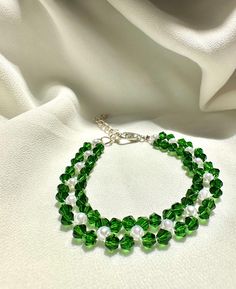 🦋our delicate bracelet is very suitable for daily wear.It can be also be given to girlfriends,daughters,mothers,stepmom,or as a birthday gifts to friends.  🦋Main materials:4mm Green rhombus crystal,white pearl. 🦋My bracelets is about 6-7 inches without extension chain so they can be suitable for most people's wrist,and if you had big wrist,still no problem with 2.5 inches extension chain. 🦋About packaging: Our bracelet is packaged in a simple white box. 🦋About shipping: we ships the order n Green Round Beads Bracelets For Mother's Day, Handmade Green Pearl Bracelet As Gift, Handmade Green Pearl Bracelet For Gift, Mother's Day Green Beaded Bracelets With Round Beads, Mother's Day Green Beaded Bracelets, Green Beaded Pearl Bracelet As A Gift, Handmade Green Crystal Bracelets, Green Crystal Bracelet, Crystal Bead Bracelet