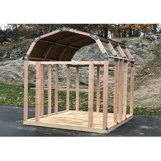 a small wooden structure sitting on top of a parking lot