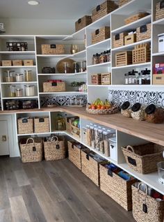 an organized pantry with lots of baskets and food on the shelves, along with other items