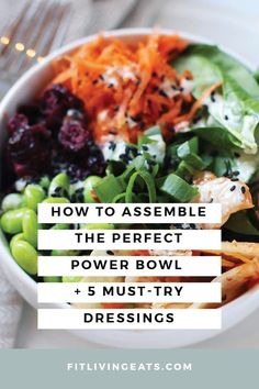 a white bowl filled with salad and vegetables on top of a table next to a fork