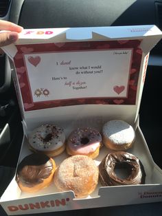 a box filled with lots of donuts sitting inside of a car