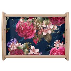 a tray with pink flowers on it and blue wallpaper behind the tray is a wooden frame