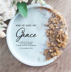 a white plate topped with granola on top of a wooden table next to flowers