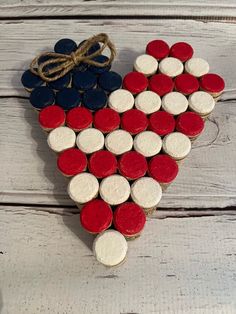 a heart made out of red, white and blue cookies on top of a wooden table