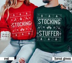 two people sitting next to each other wearing matching christmas sweaters