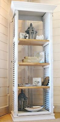 a white shelf with books and other items on it