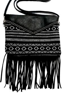 Leather and woven fabric purse handmade in Mexico Black and white Fringed and studded Adjustable shoulder strap Mid-size.  Perfect for makeup and a phone 14 x 11 x 1" overall with fringe The purse portion (without the fringe) is 11 x 8 x 1" Check out our many items from Mexico including more bags and purses by clicking here Black Fringed Shoulder Bag For Festival, Black Fringe Shoulder Bag For Festival, Mexico Black And White, Mexican Purse, Fabric Purse, Purse Handmade, Fabric Purses, The Fringe, Purse Black