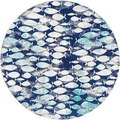 a circular rug with blue and white fish in the middle, on a white background