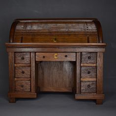 an old wooden desk with many drawers