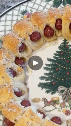 a plate with pigs in a blanket on it and a christmas tree decoration behind it