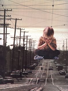 a young boy jumping in the air on top of a skateboard with power lines above him