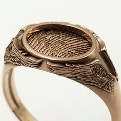 "Free first class shipping on all items with standard gift box! Free priority shipping on orders over $140 with upgraded gift box! U.S. shipments only These memorial rings feature a set of angel wings on each side of the ring with the one being memorialized fingerprint framed in a halo inside the ring. They really are a very nice and fitting. These can be made in silver, yellow gold, and/or white gold. The print can be cut in a different metal than the ring for contrast or they can both be made Unique Rings With Engraving Option For Gift, Unique Stamped Engraved Ring As Gift, Unique Engraved Ring As Gift, Unique Engraved Ring With Stamped Detail As Gift, Unique Engraved Stamped Ring As Gift, Oval Etched Signet Ring As Gift, Oval Etched Signet Ring Gift, Modern Engraved Ring With Engraving Option As Gift, Etched Oval Ring For Gift