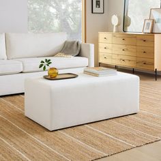 a white couch and ottoman in a living room