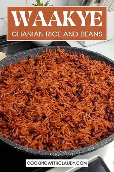 a large pan filled with beans and rice on top of a stove next to a sign that reads waakve ghan rice and beans