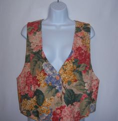 "Vintage Facets by Mirrors khaki, blue and pink hydrangeas floral flower print vest or waistcoat.  Good pre-owned condition.  No holes, stains, rips, tears, fading, etc.  Women's size 8 or 10 or MEDIUM.  Measurements:  bust-38\", length-23\".  Button front closure.  88% cotton, 12% flax.  Lined.  Made in the U.S.A." Vintage Fitted Vest For Spring, Casual Cotton Vest With Floral Print, Flower Vest, Fitted Cotton Vest With Floral Print, Fitted Cotton Vest With Floral Embroidery, Multicolor Floral Print Summer Vest, Vintage V-neck Vest For Spring, Sleeveless Cotton Vest With Floral Print, Fitted Floral Print Sleeveless Vest