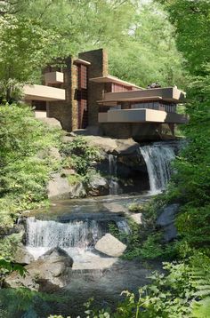 an artistic rendering of a house in the woods with water flowing down it's side