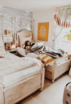 a child is laying on the bed in a bedroom with blue and white wallpaper