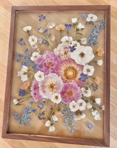 a wooden frame with flowers painted on it