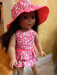 a doll wearing a pink hello kitty dress and hat