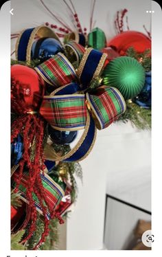 a christmas wreath with ornaments hanging from it