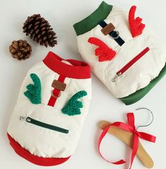 two dog sweaters made to look like snowmen with red and green trimmings