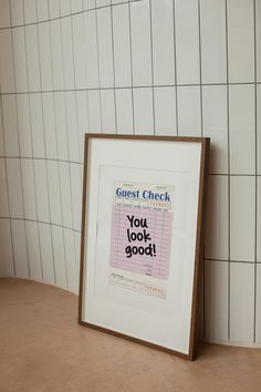 a framed poster with the words guest check on it