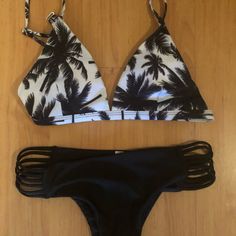 Black An White Bikini Set New Never Worn Both Pieces Size Small. Very Cute Suit! Tropical Black Triangle Top Swimwear, Black Triangle Top Swimwear With Cutout, Black Cutout Triangle Top Swimwear, Black Tropical Swimwear For Beach Party, Black Strappy Tankini For Poolside, Black Beachy Swimwear For Party, Black Beach Party Swimwear, Black Triangle Top Tankini For Beach Party, Black Strappy Swimwear For Beach Party