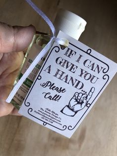 a hand holding a bottle with an ad on it that says if i can give you a hand please call