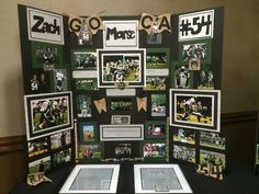 a table topped with pictures and photos of football players on display in front of a wall