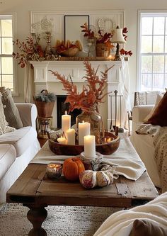 a living room filled with lots of furniture and candles on top of a coffee table