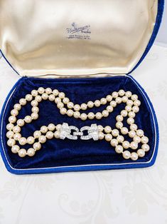 Vintage Carolee Cream Colored Glass Pearl Necklace Clear Rhinestone Clasp Bridal Necklace Wedding Necklace Vintage designer Carolee's glass pearl necklace that features a gorgeous clear rhinestone clasp.  The pearl color is a creamy color. The clasp can be worn on the side as pictured or to the back.  The pearls are such a nice weight and the entire necklace is a prime example of Carolee's nice designs.  The necklace dates to the 1970s. Matching bracelet is in my shop here: https://www.etsy.com/listing/1758940698/carolee-creamy-pearl-bracelet-beautiful This is a pretty necklace for a bride on her special day. *Presentation box is for display purposes only and is not included in the listing. Elegant Pearl Jewelry For Vintage Events, Formal Costume Pearl Necklace, Vintage Single Strand Pearl Necklace For Wedding, Classic Crystal Pearl Necklace For Wedding, Classic Rhinestone Necklaces For Formal Occasions, Formal Crystal Jewelry With Pearl Chain, Formal Crystal Bridal Necklace With Round Beads, Single Strand Crystal Jewelry For Wedding, Formal Pearl White Costume Jewelry Necklace