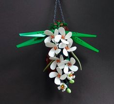 a bunch of white flowers hanging from a chain